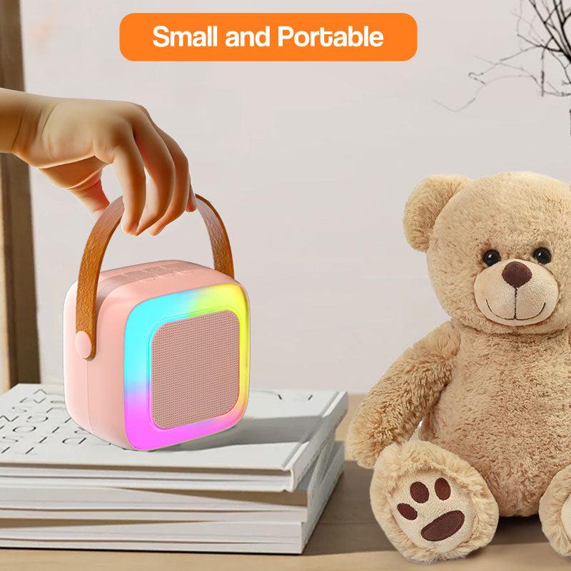 Family Fun Karaoke Machine small portable kids microphone with colorful LED light and handle next to teddy bear