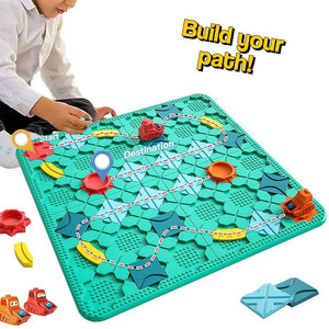 Child playing Build-A-Path Logic Puzzle STEM game with wind-up bulldozer on green board and colorful track pieces